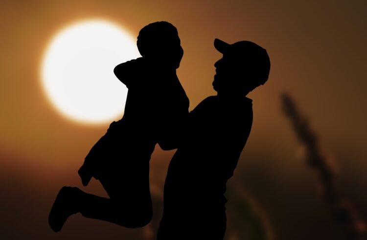 Dad with hat and son in moonlight